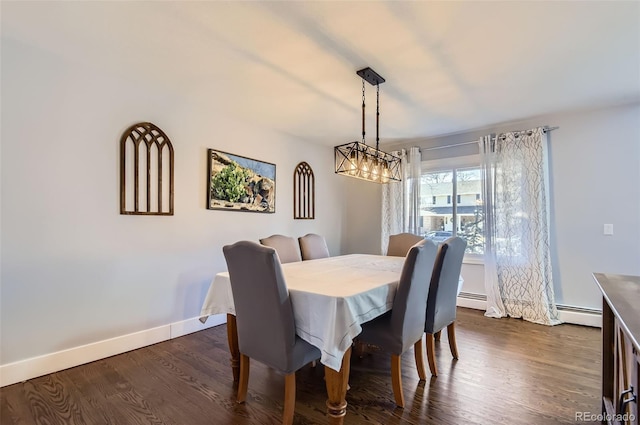 dining room with dark wood-type flooring, a baseboard heating unit, and a chandelier