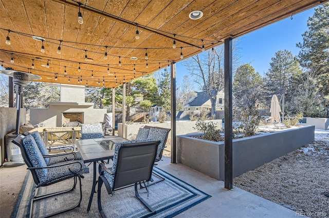 view of patio / terrace featuring exterior fireplace