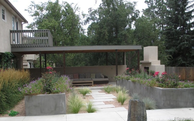 exterior space with an outdoor living space with a fireplace