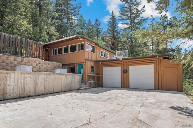 5732 Santa Clara Rd, Indian Hills, CO 80454 - view of home's exterior with driveway, board and batten siding, and a garage