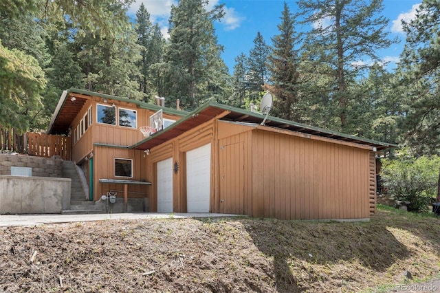 5732 Santa Clara Rd, Indian Hills, CO 80454 - back of house featuring stairway and an attached garage