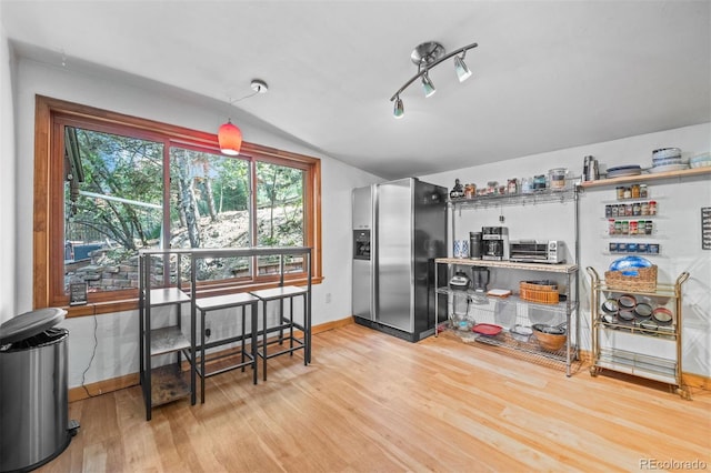 5732 Santa Clara Rd, Indian Hills, CO 80454 - kitchen with stainless steel fridge with ice dispenser, vaulted ceiling, and wood finished floors