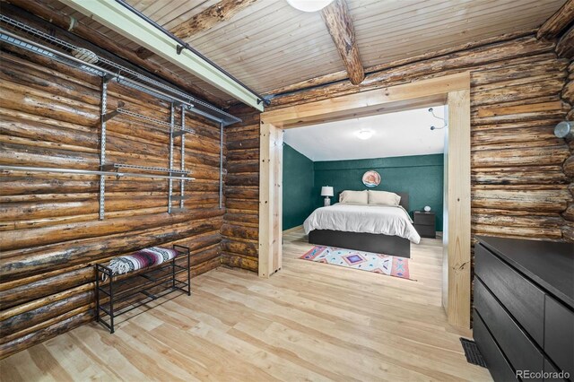 5732 Santa Clara Rd, Indian Hills, CO 80454 - bedroom featuring rustic walls, wood finished floors, and a wooden ceiling with exposed beams