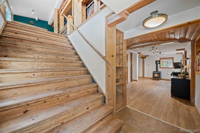 5732 Santa Clara Rd, Indian Hills, CO 80454 - stairway with a wood stove, a chandelier, and wood finished floors