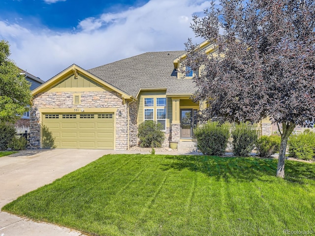 581 N Flat Rock Cir, Aurora, CO 80018 - craftsman house with stone siding, a front lawn, concrete driveway, roof with shingles, and a garage