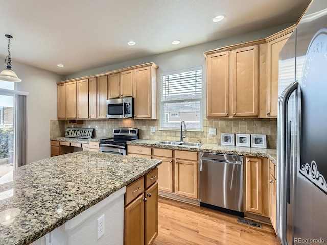 581 N Flat Rock Cir, Aurora, CO 80018 - kitchen with stainless steel appliances, light wood-type flooring, backsplash, light stone counters, and light brown cabinetry