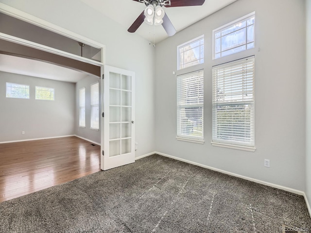 581 N Flat Rock Cir, Aurora, CO 80018 - empty room featuring french doors, carpet flooring, ceiling fan, and arched walkways