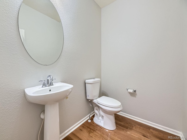 581 N Flat Rock Cir, Aurora, CO 80018 - bathroom with wood finished floors and toilet