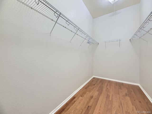 581 N Flat Rock Cir, Aurora, CO 80018 - walk in closet featuring wood finished floors and attic access