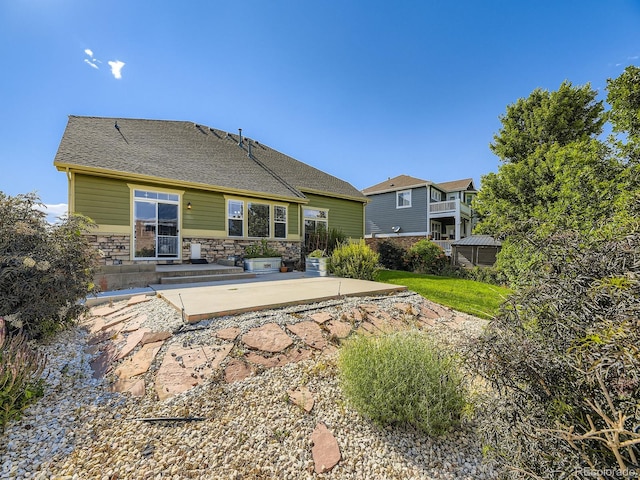 581 N Flat Rock Cir, Aurora, CO 80018 - rear view of property with a patio and stone siding