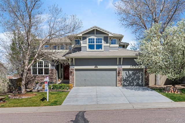 view of front of property with a garage and a front lawn