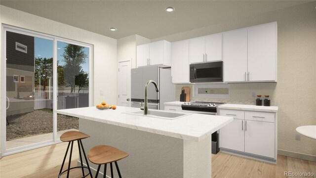 46517 Sunflower Ln, Bennett, CO 80102 - kitchen with stainless steel electric stove, light wood-type flooring, white cabinetry, fridge, and a sink