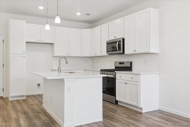 6902 Huddersfield Ln, Castle Pines, CO 80108 - kitchen featuring appliances with stainless steel finishes, a sink, light wood-type flooring, decorative backsplash, and recessed lighting