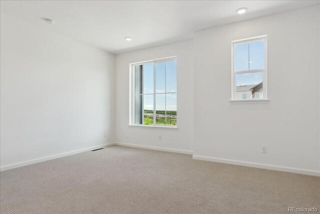 6902 Huddersfield Ln, Castle Pines, CO 80108 - empty room featuring light colored carpet, baseboards, and recessed lighting