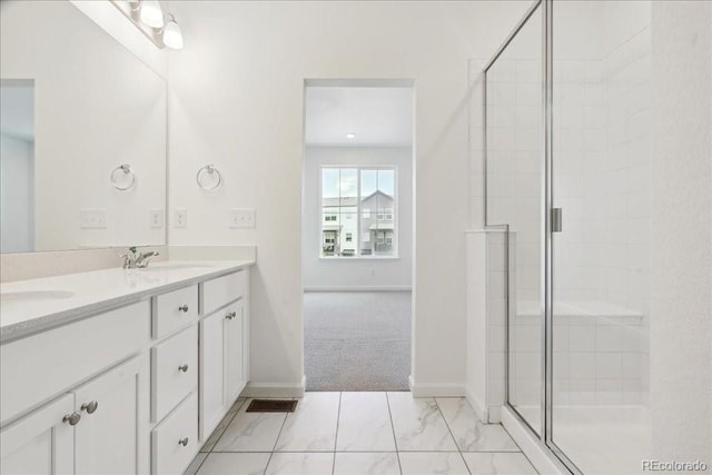 6902 Huddersfield Ln, Castle Pines, CO 80108 - bathroom featuring double vanity, a shower stall, marble look tiles, and baseboards