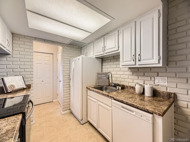 1932 S Oswego Way, Aurora, CO 80014 - kitchen featuring dishwasher, a sink, white cabinetry, electric range oven, and brick wall