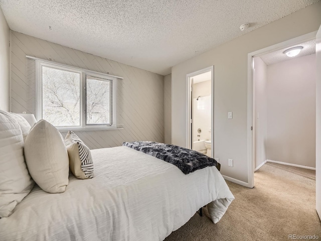 1932 S Oswego Way, Aurora, CO 80014 - bedroom with a textured ceiling, light carpet, connected bathroom, wooden walls, and baseboards