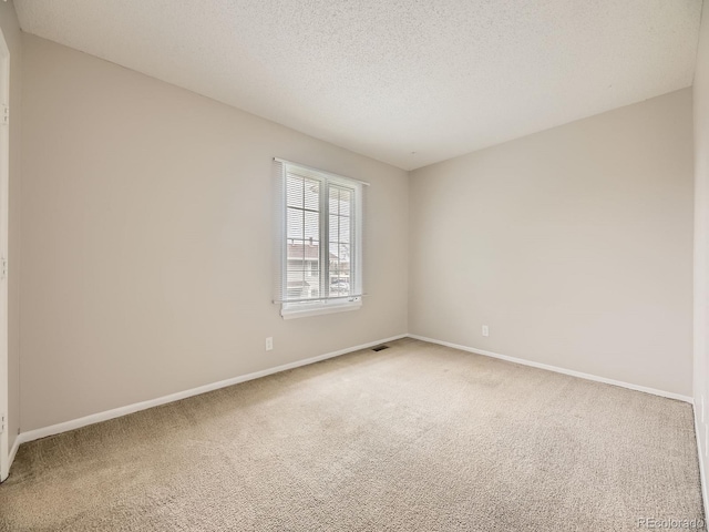 1932 S Oswego Way, Aurora, CO 80014 - carpeted empty room with baseboards and a textured ceiling