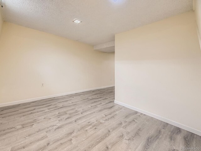 1932 S Oswego Way, Aurora, CO 80014 - unfurnished room with light wood-style flooring, baseboards, and a textured ceiling