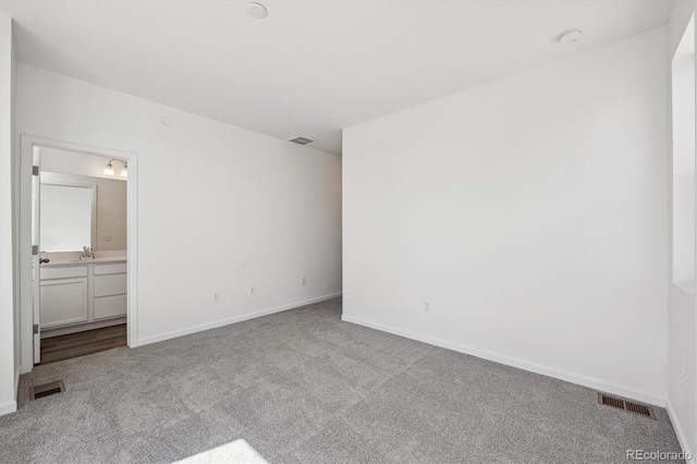 1368 Penner Dr, Erie, CO 80026 - unfurnished bedroom with carpet floors, baseboards, a sink, and connected bathroom