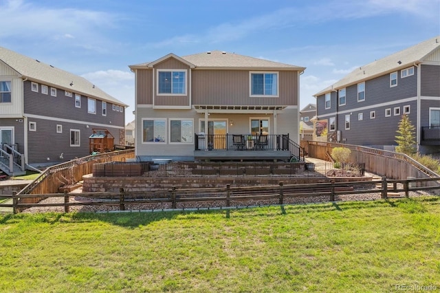 back of property featuring a deck and a garden