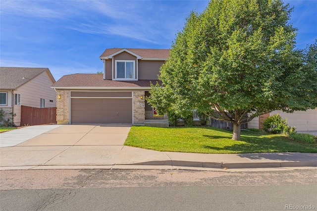 view of front of house with a garage and a front lawn