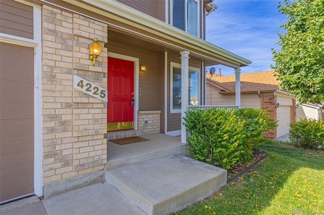 entrance to property with a lawn and a garage