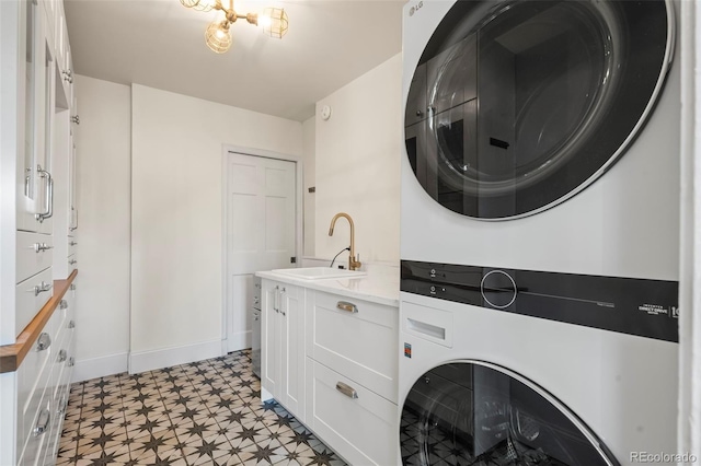 laundry area featuring stacked washing maching and dryer and sink