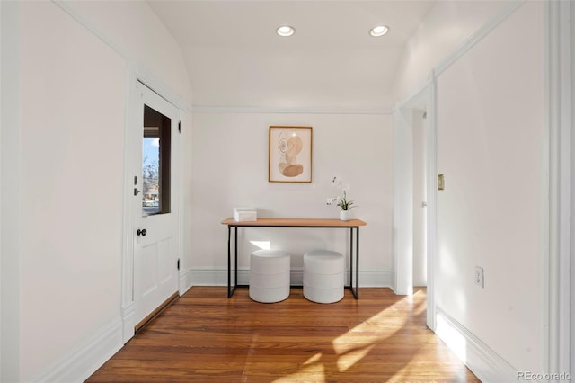 entryway with vaulted ceiling and hardwood / wood-style floors