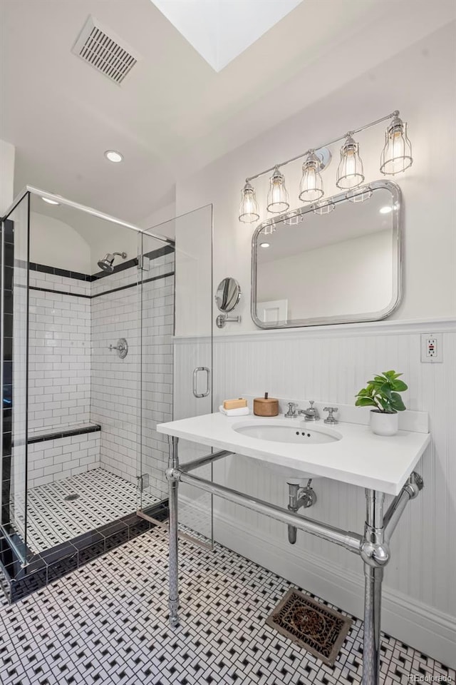 bathroom featuring walk in shower, tile patterned floors, and sink