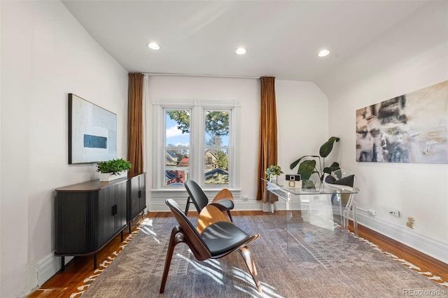 interior space featuring lofted ceiling and dark wood-type flooring