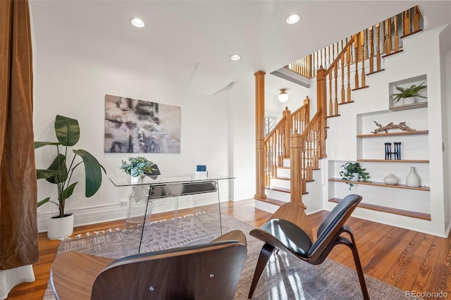 sitting room featuring ornate columns and hardwood / wood-style floors