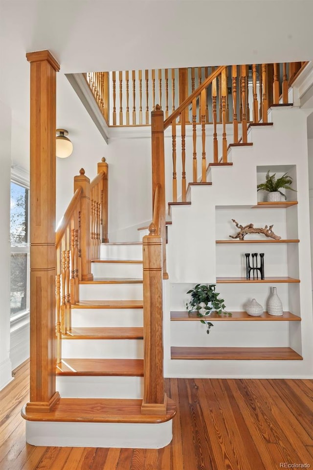 stairs featuring hardwood / wood-style floors