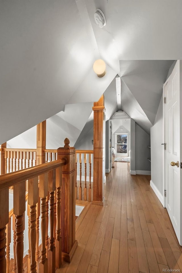 bonus room with lofted ceiling and wood-type flooring