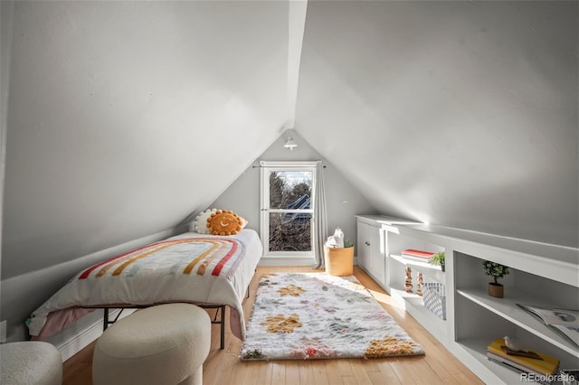 bedroom with lofted ceiling and light hardwood / wood-style flooring