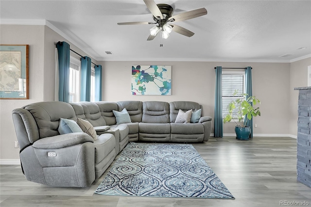 living room featuring crown molding, ceiling fan, and hardwood / wood-style flooring