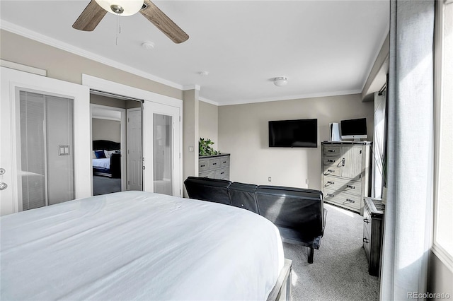 carpeted bedroom with ornamental molding and ceiling fan