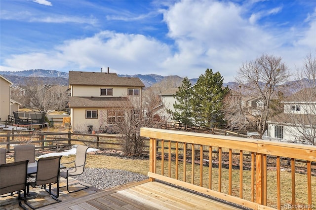 wooden terrace with a mountain view and a trampoline