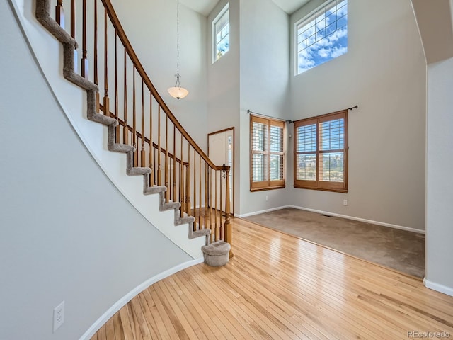 carpeted foyer with a high ceiling