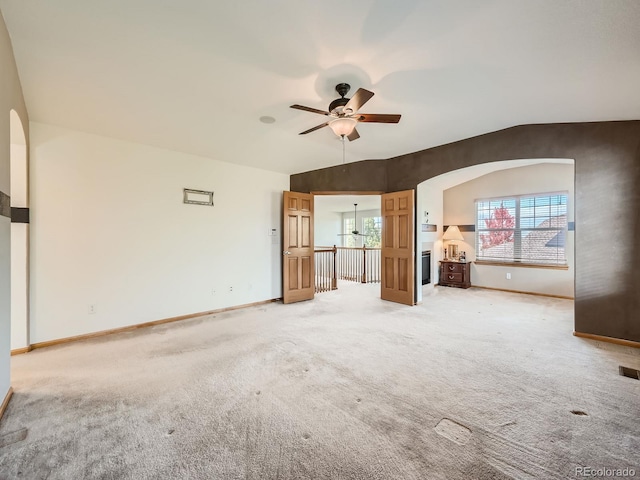 unfurnished living room with lofted ceiling, carpet floors, and ceiling fan