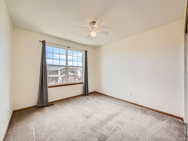 carpeted spare room with ceiling fan