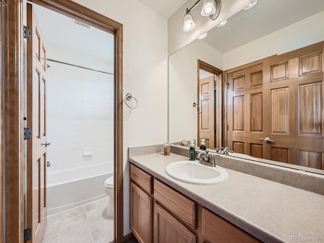 full bathroom featuring bathtub / shower combination, vanity, toilet, and tile patterned floors