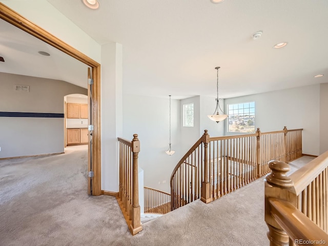 stairway with lofted ceiling and carpet flooring