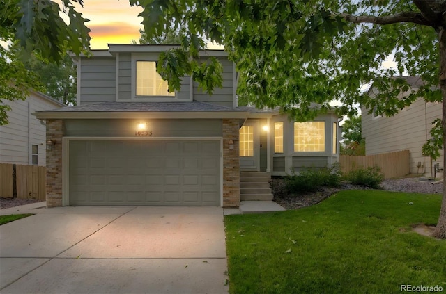 view of front facade with a garage and a yard