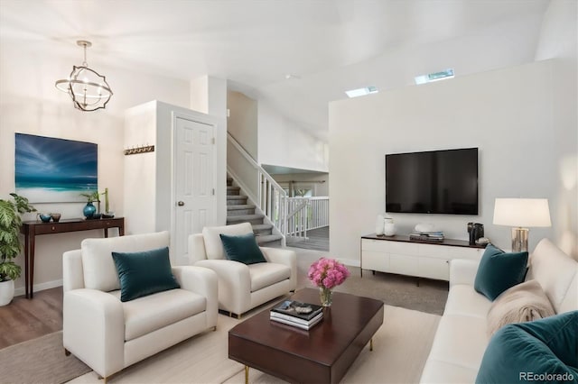 living room with an inviting chandelier and vaulted ceiling