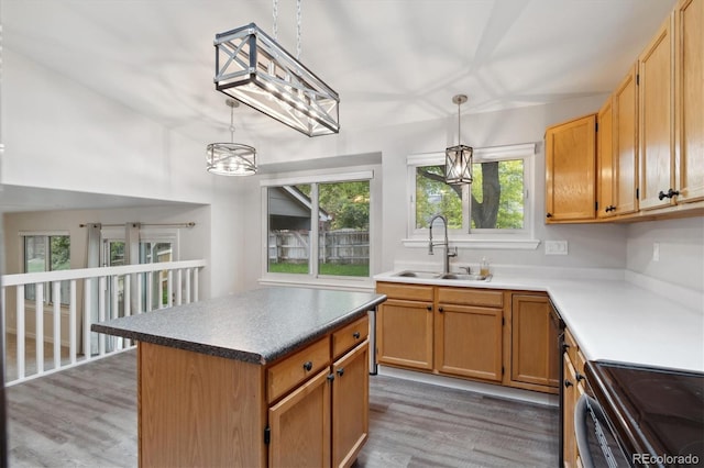 kitchen featuring sink, electric range, a center island, dark hardwood / wood-style flooring, and decorative light fixtures