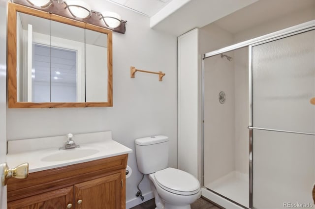 bathroom with vanity, an enclosed shower, and toilet