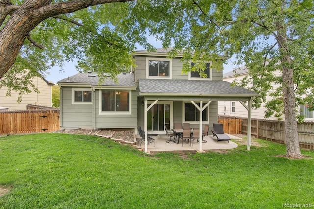 rear view of house with a yard and a patio area