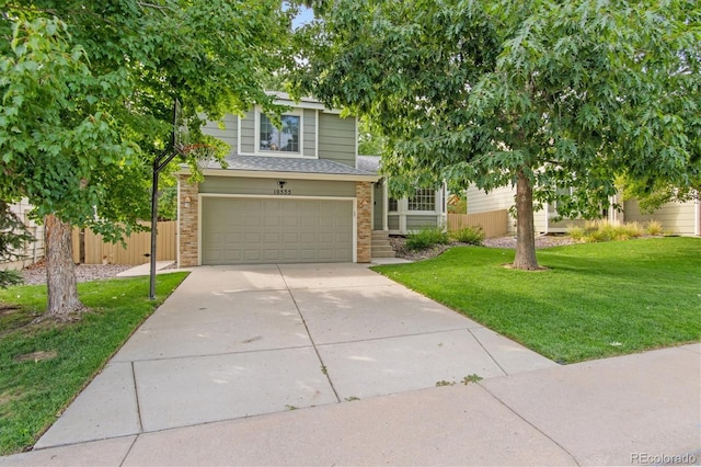 view of front of house featuring a garage and a front lawn