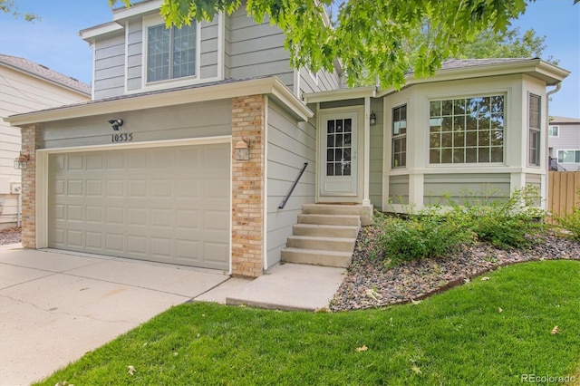 view of front facade with a garage and a front yard